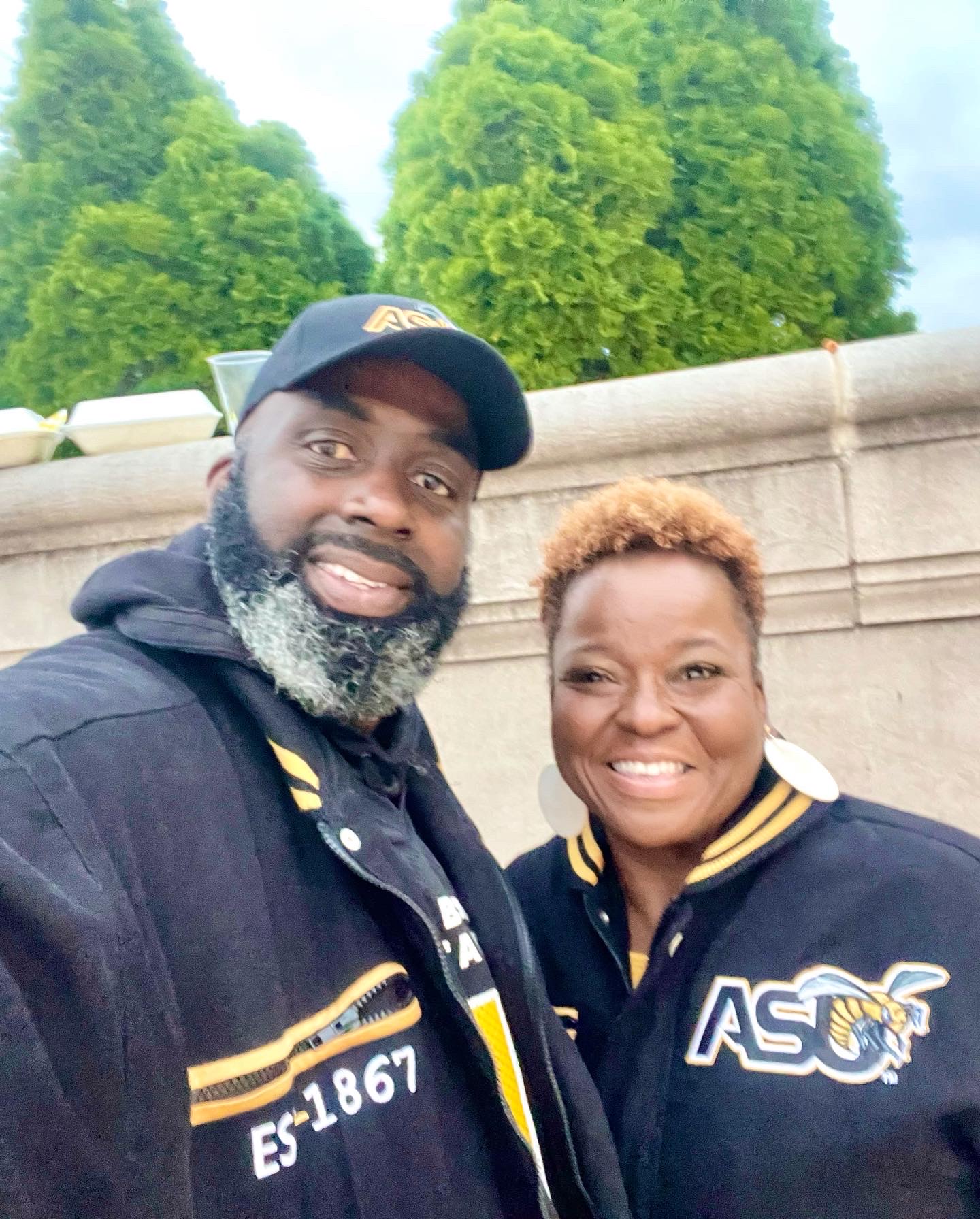 DeeDee and Ken smiling together in matching Alabama State University jackets